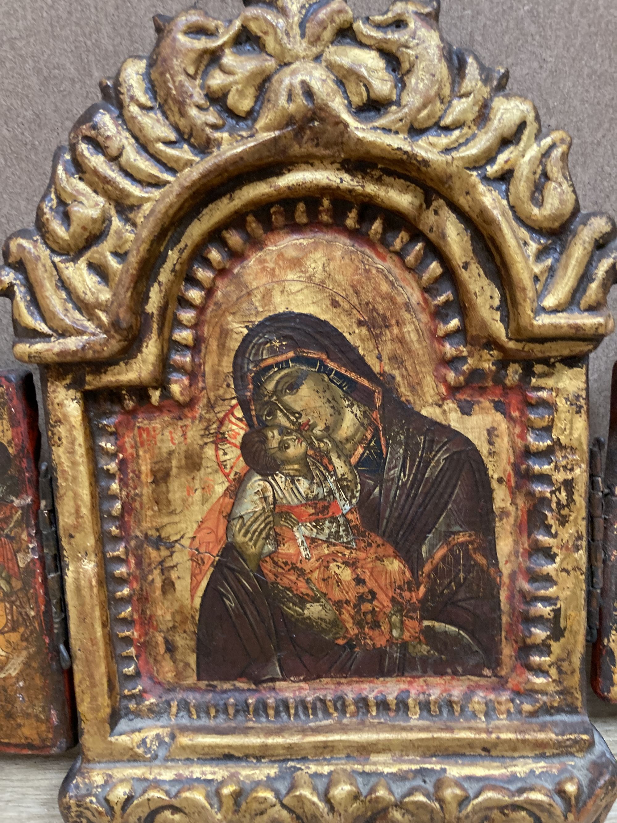 A tempera on wood triptych icon, height overall 25cm and a single Virgin and child icon, 21 x 17cm